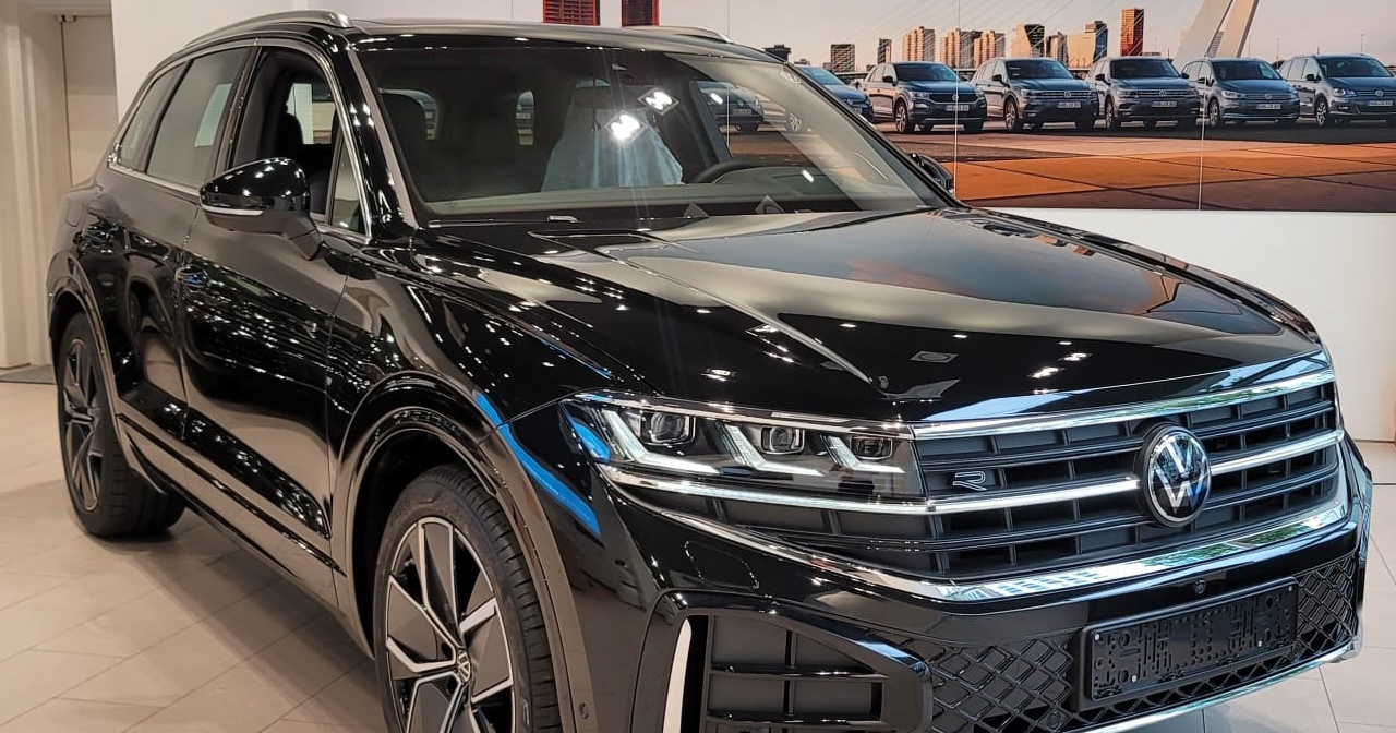 Order from Volkswagen dealership with a variety of new 2024 model vehicles on display.
